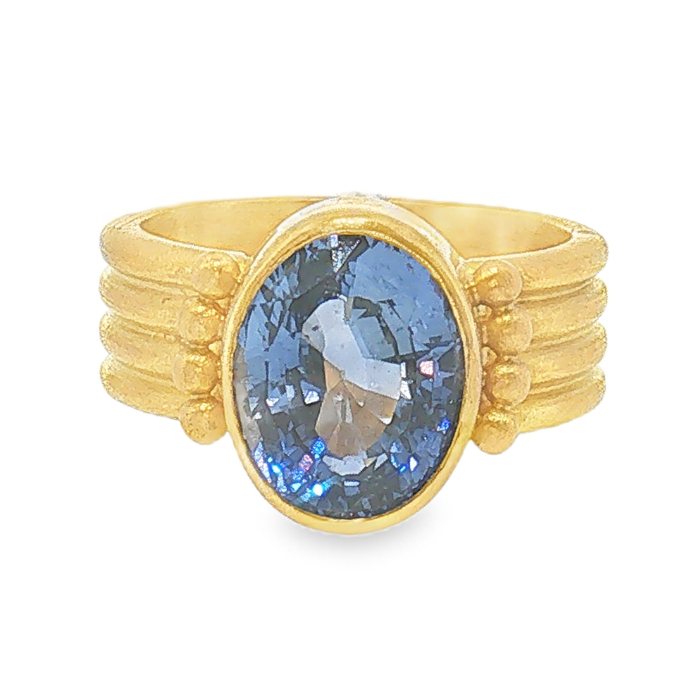 20k yellow gold oval shaped ring set with one oval sapphire approximately (3.40ct) in a yellow gold bezel setting.