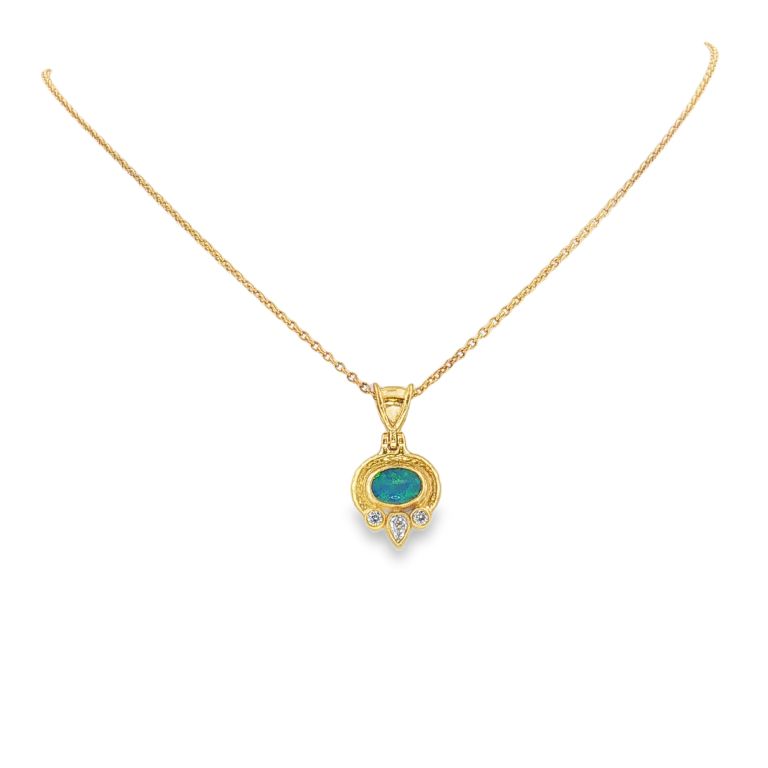 24k yellow gold opal and diamond necklace set with 1 oval shaped opal (.70ct) and 1 pear shaped diamond (.10ct) and 2 round cut diamonds (.10ctw).