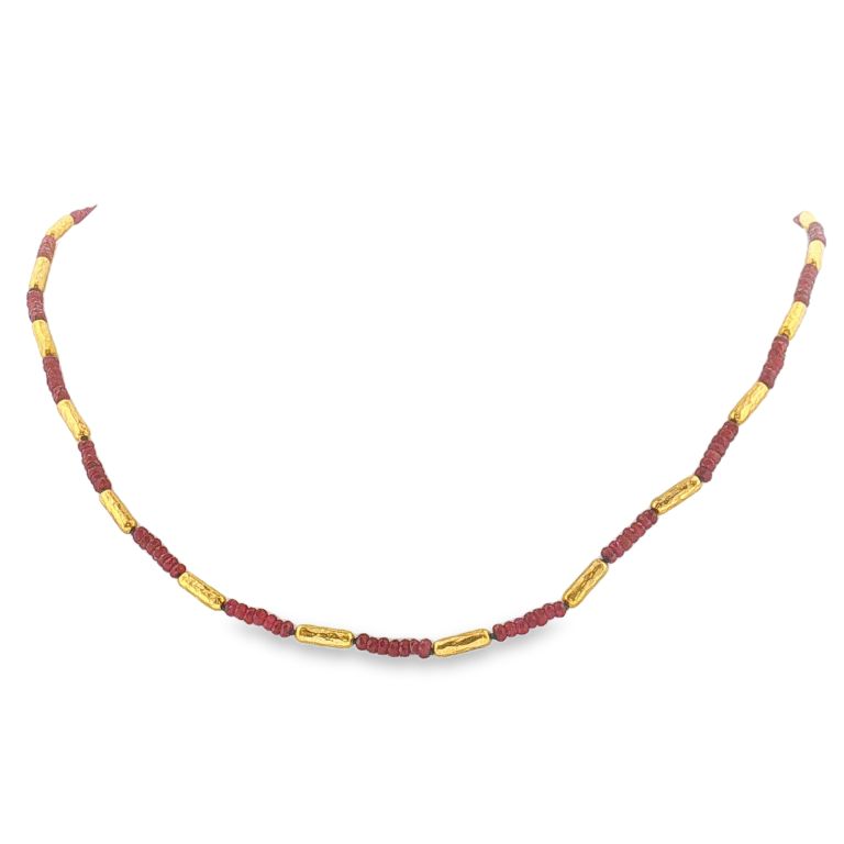 24k yellow gold necklace with faceted ruby beads and 20 gold tubular stations.