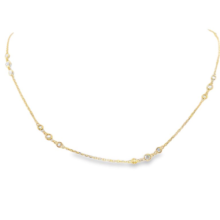 18k yellow gold diamond station necklace set with 21 round diamonds (VS-SI) (.93ctw) with a length of 18 inches.