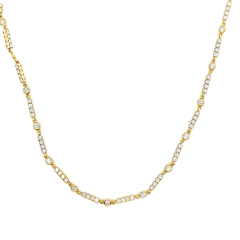18k yellow gold diamond station necklace set with 11 round diamonds (FG/VS) (.80ctw) with a length of 18 inches.